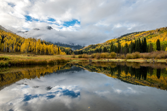 Mt. Sneffels reflects in a pond in Colorado in the fall