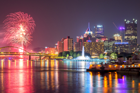 Bright red fireworks and Pittsburgh from the South Shore