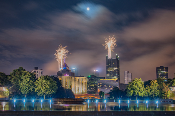 Fireworks and the moon over Pittsburgh