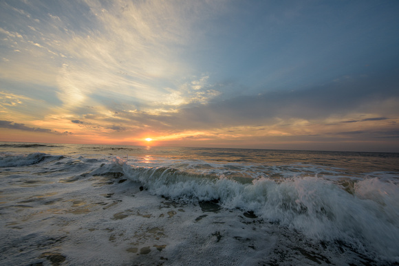 Waves crash into the shore in Ocean City, MD at dawn