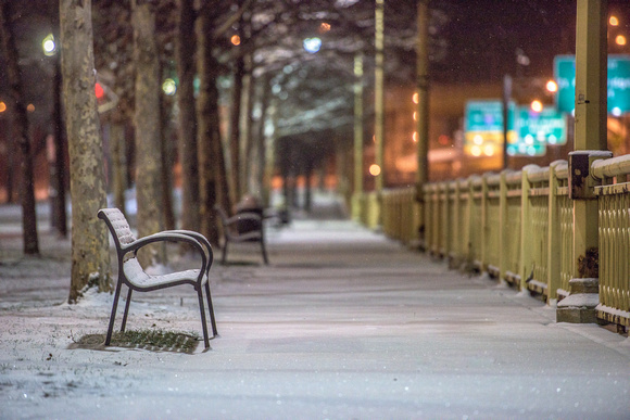 A snowy bench sits in downtown Pittsburgh