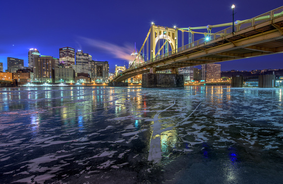 The Roberto Clemente Bridge reflects int he icy Allegheny