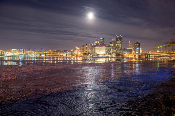 A full moon reflects in the icy Ohio River in Pittsburgh