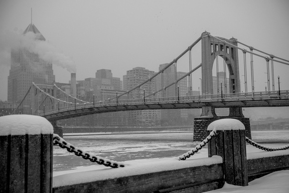 Black and white view of snow falling on Allegheny Landing