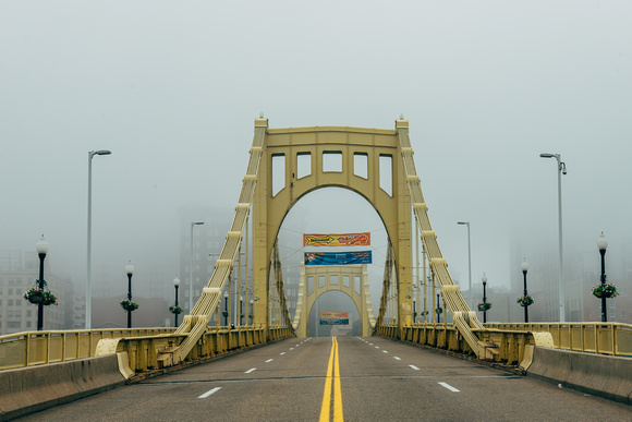 Pittsburgh disappears into the fog behind the Roberto Clemente Bridge