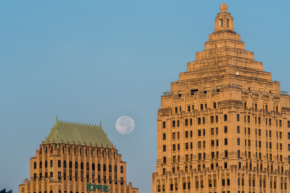 A full moon between the Gulf Tower and Koppers Building in PIttsburgh