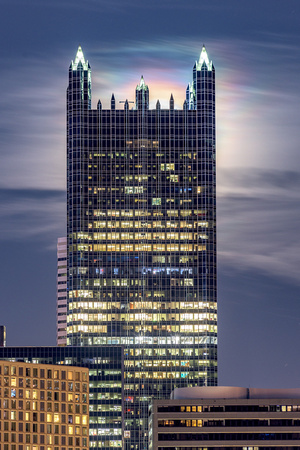 A rainbow emerges from behind PPG Place as the moon lights up the night