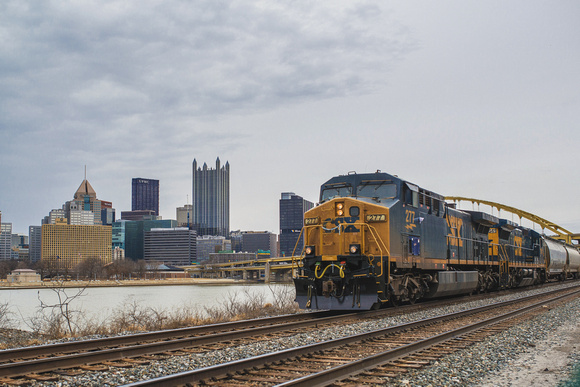 Train along the Ohio River with Pittsburgh in the background