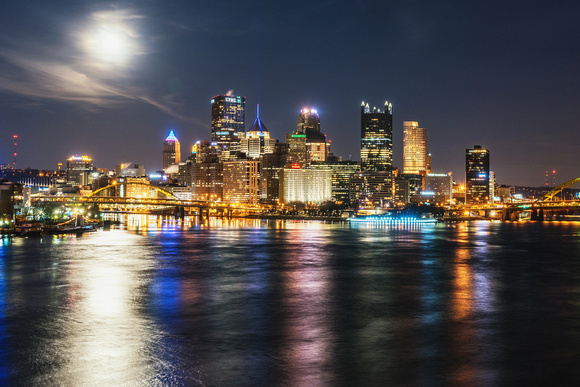 The full moon shines above Pittsburgh from the West End Bridge