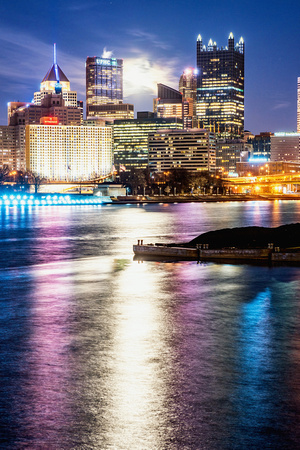 A full moon sits in the Pittsburgh skyline