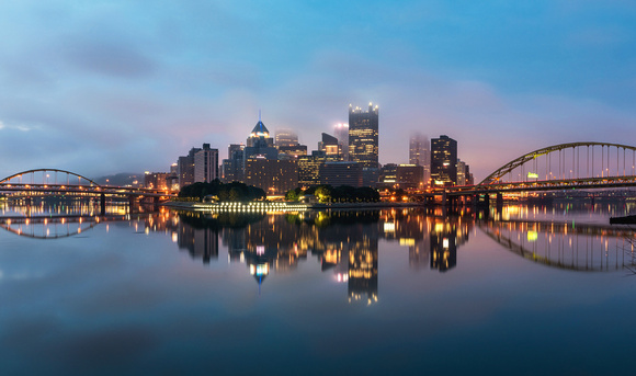 Downtown Pittsburgh reflects in the rivers on a foggy morning
