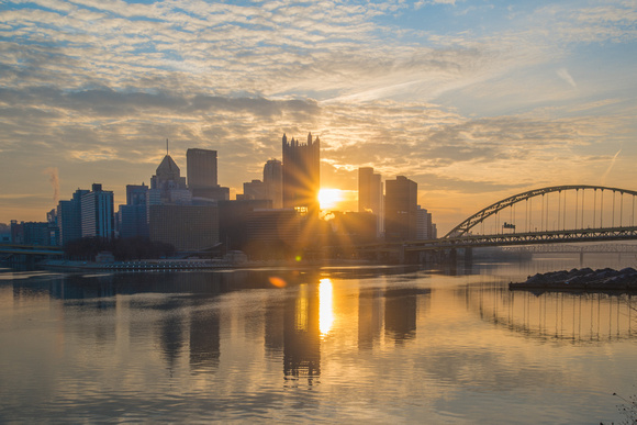 Sunflare through the Pittsburgh skyline at dawn