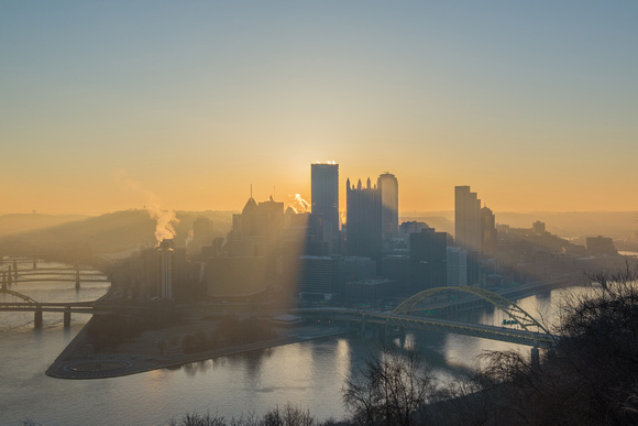 Sun hidden behind Steel Building in Pittsburgh at dawn