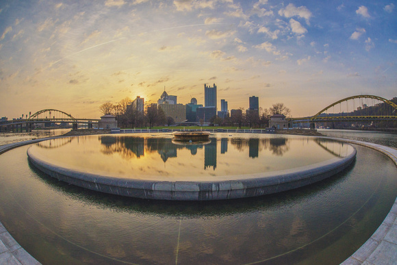 Pittsburgh reflects in the fountain pool at Point State Park at sunrise