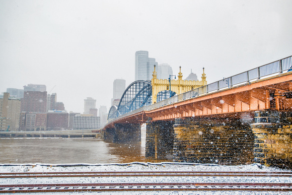 Snow falls around the Smithfield Street bridge in Pittsburgh
