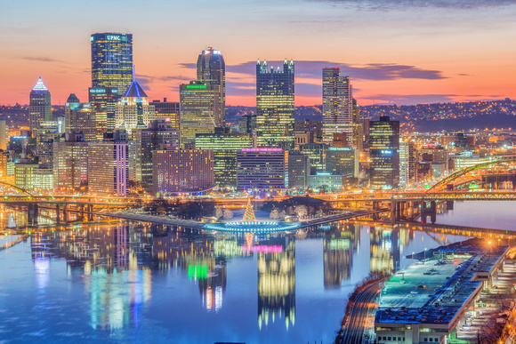 Pittsburgh sits below a colorful sky as seen from the West End Overlook