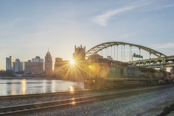 Train and Pittsburgh skyline with the sun early in the morning