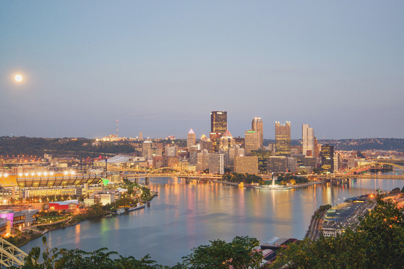 The moon low over the Pittsburgh skyline and the Giant Rubber Duck
