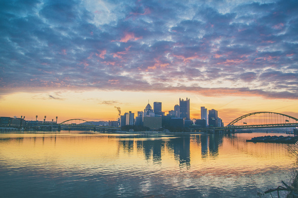 Pittsburgh is layered between clouds during a beautiful sunrise