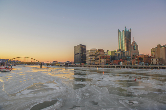 The sunset glows over the Pittsburgh skyline from the Smithfield Street Bridge