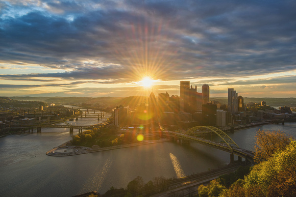 Sunflare through the Pittsburgh skyline at dawn from Mt. Washington