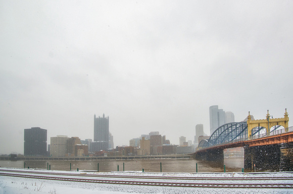 A snowy Pittsburgh skyline in winter from Station Square