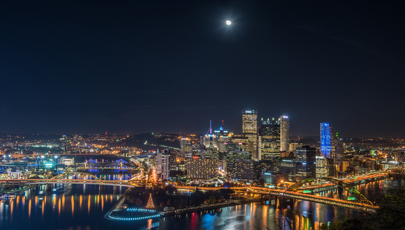 The moon shines above Pittsburgh during Light up Night 2016