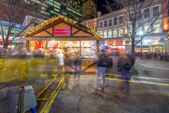 People rushing by vendors in Market Square on Light Up NIght in Pittsburgh