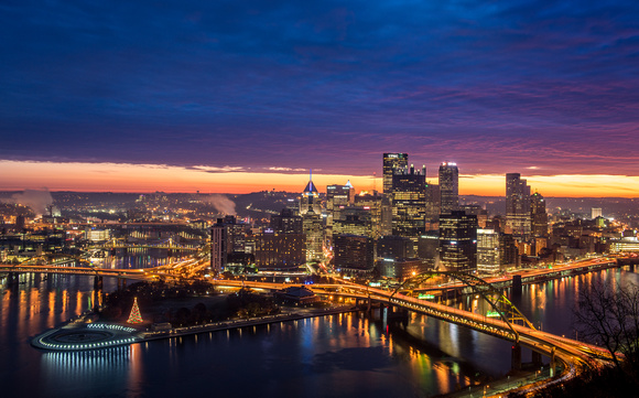 A thin band of color fills the sky over Pittsburgh before dawn
