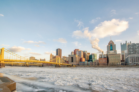 Pittsburgh skyline and the Roberto Clemente Bridge from across the ice covered Allegheny River HDR