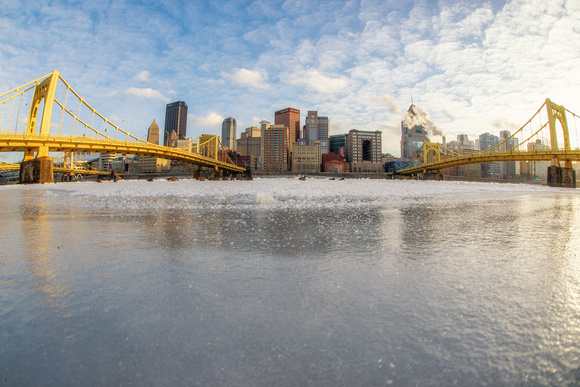 View of the Pittsburgh skyline in winter by the icy Allegheny River HDR