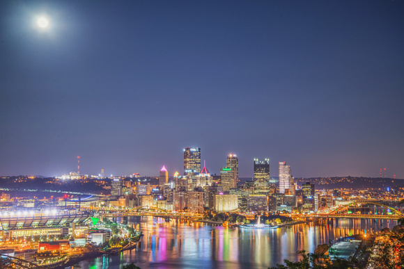 The full moon shines over Pittsburgh and the Giant Rubber Duck