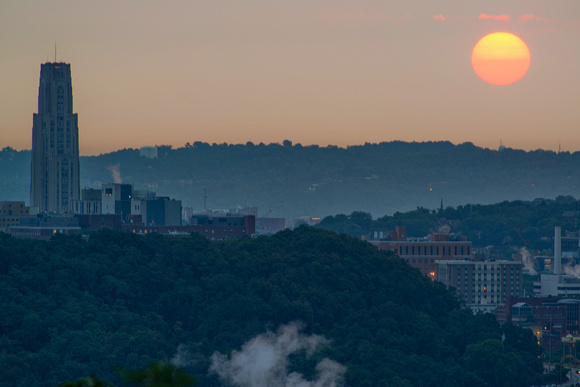 The sun rising by the Cathedral of Learning in Pittsburgh