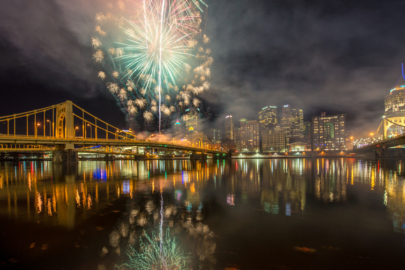 The fireworks from Light Up Night reflect in the Allegheny River in Pittsburgh