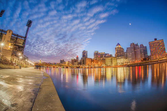 A fisheye view of the North Shore with Pittsburgh reflecting in the Allegheny River