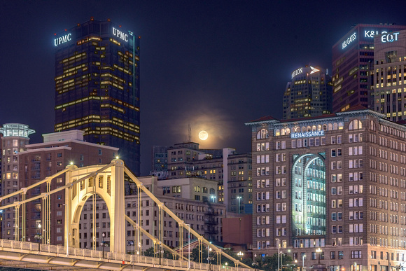 The full moon hangs over the Clemente Bridge