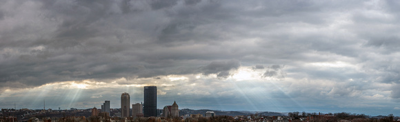 Panorama of sun rays through clouds over the Pittsburgh skyline