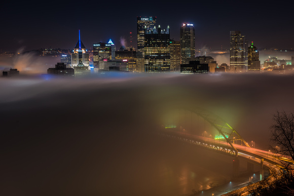 Pittsburgh is engulfed in fog as the Ft. Pitt Bridge glows in the early morning