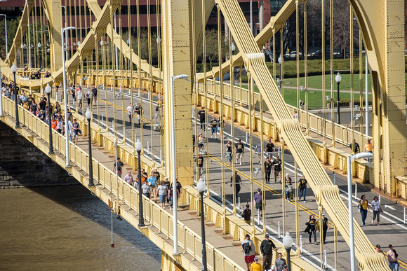 Wans walk over the Roberto Clemente Bridge after the Pittsburgh Pirates Opening Day win