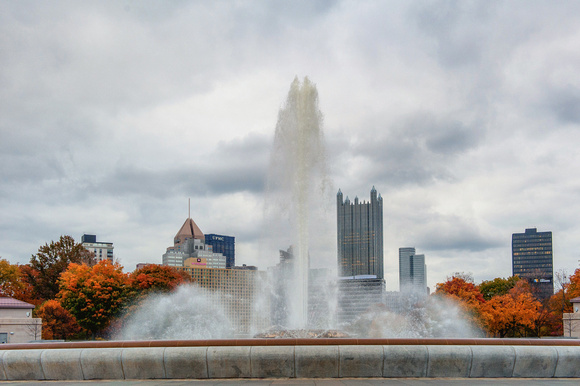 The fountain rises in front of Pittsburgh in the fall