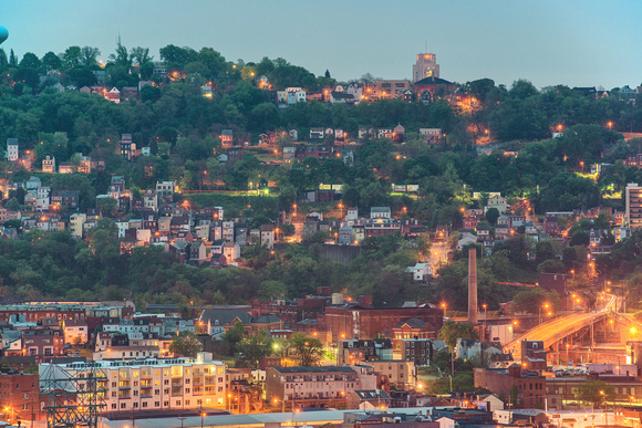 A hill is lit up in Pittsburgh before dawn