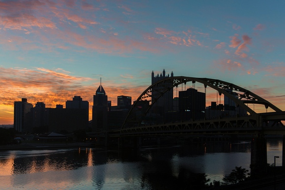 A colorful sunrise over a silhouetted Pittsburgh