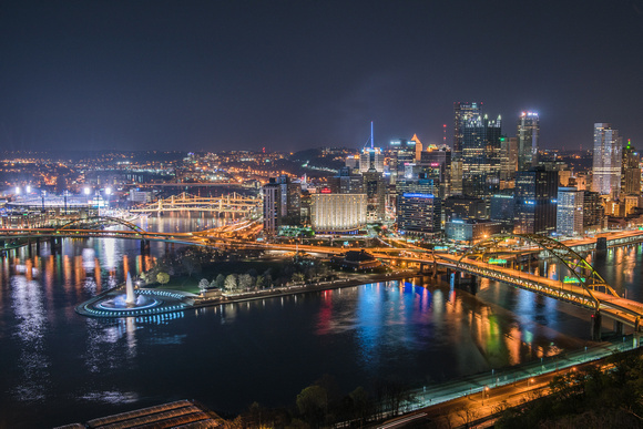Pittsburgh skyline with the fountain and PNC Park lit up at night