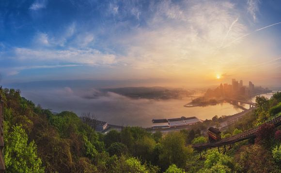 A foggy panorama of Pittsburgh at dawn