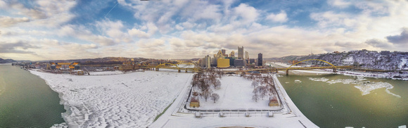 Panorama of a snowy Pittsburgh skyline from above Point State Park