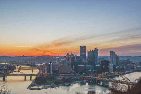 Pittsburgh skyline under a fire red sky at dawn