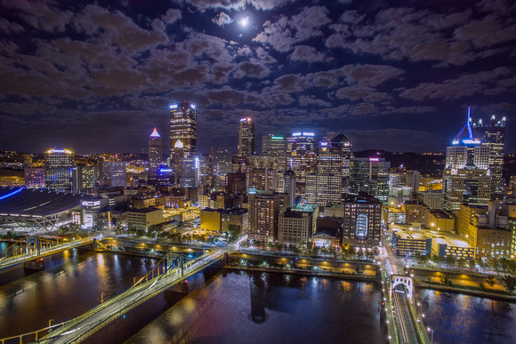 The full moon hangs over Pittsburgh in an aerial view above the North Shore
