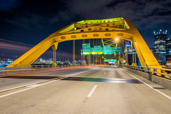 Cars race over the Ft. Pitt Bridge in Pittsburgh early in the morning