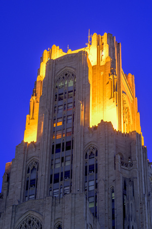 The Victory Lights atop the Cathedral of Learning shine bright against a blue sky