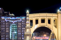 The top of the Clemente Bridge and the Bat Signal on the Renaissance